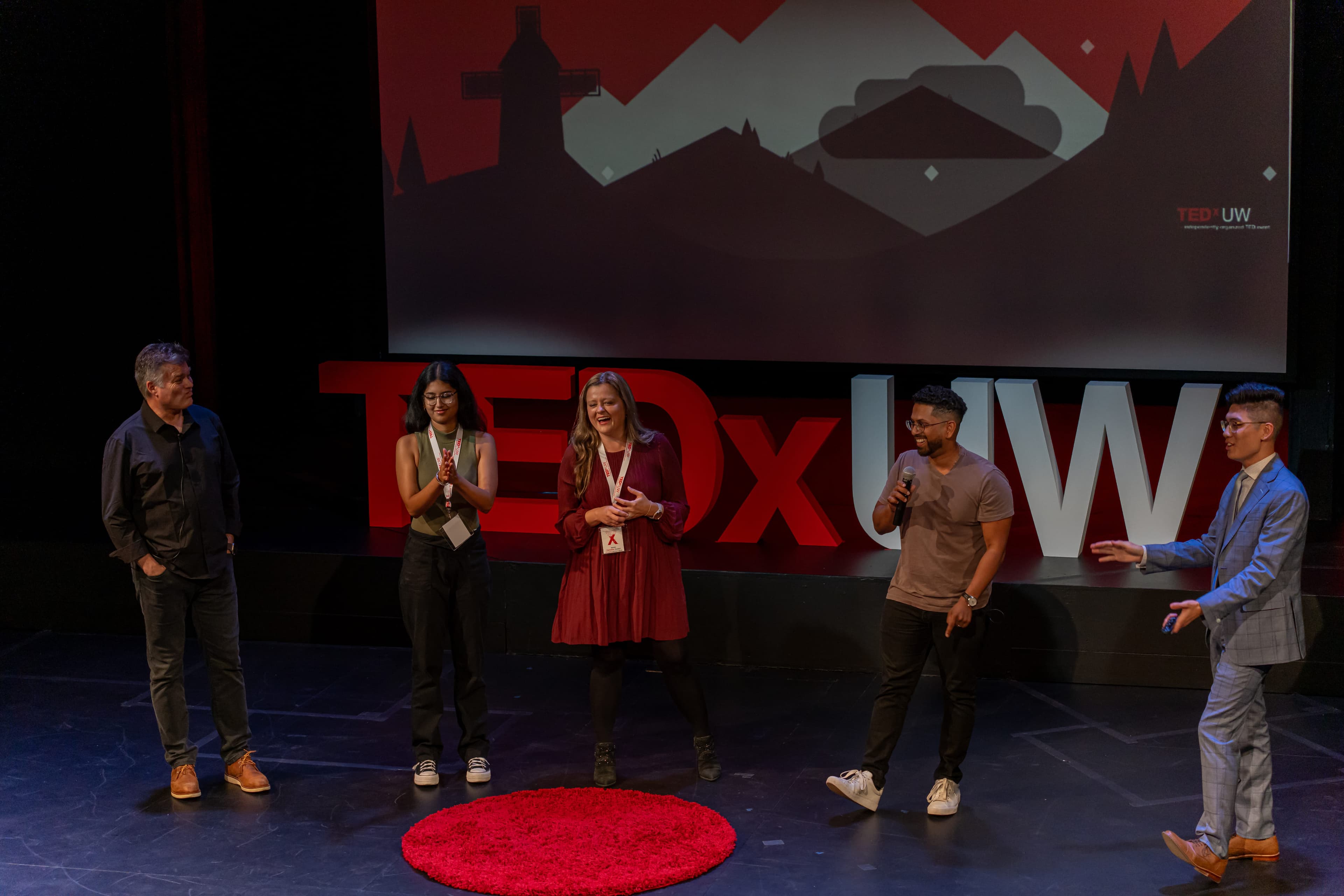 Speakers on stage at a TEDx UW event